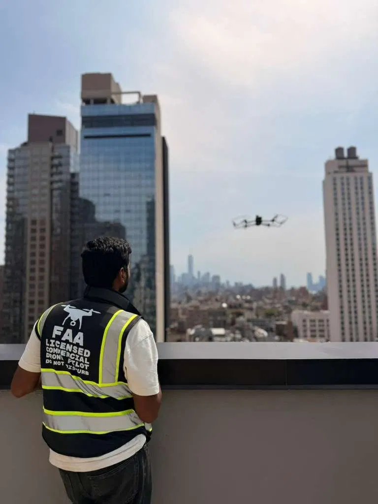 FAA-licensed commercial drone pilot conducting a facade inspection over the Manhattan skyline